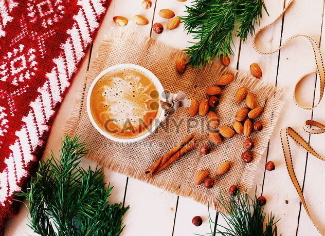 Cup of coffee, nuts and cinnamon on sacking - бесплатный image #136241