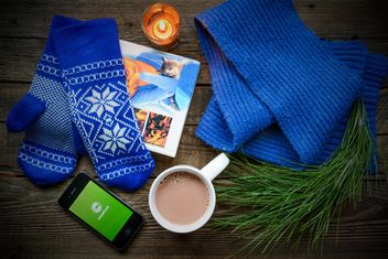 Book, coffee, warm woolen clothes and candle on the wooden table - image #182791 gratis