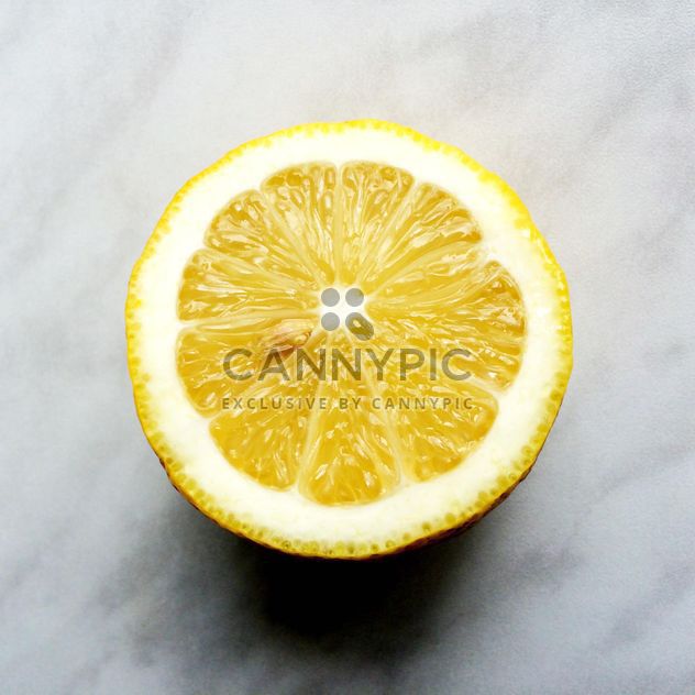 Half of lemon on a gray background - image gratuit #183221 