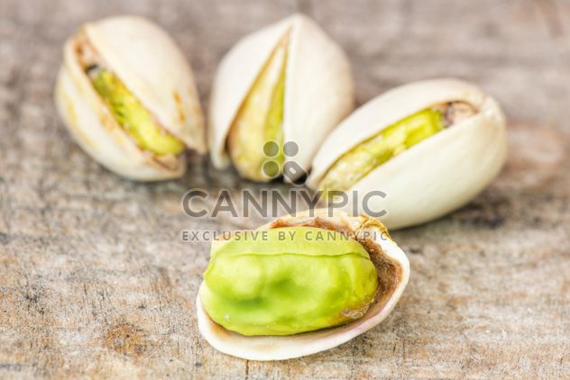 Pistachios on wooden background - Kostenloses image #271601