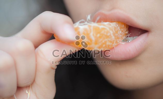 Girl eating peeled tangerine - image gratuit #301941 