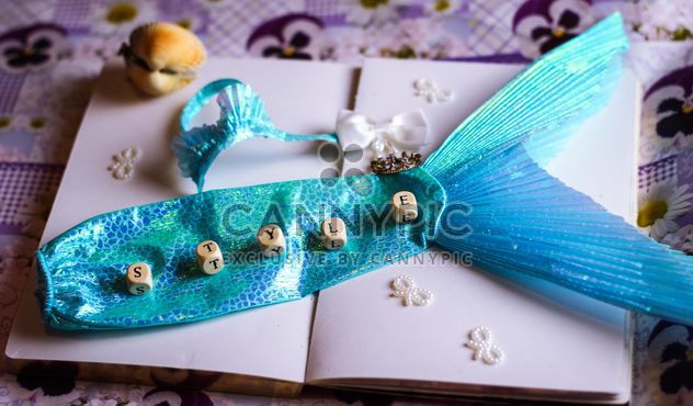 Decorative mermaid tail on a note book - image #302521 gratis
