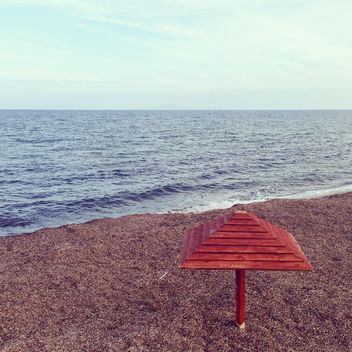 Wooden umbrella on seashore - image gratuit #332051 