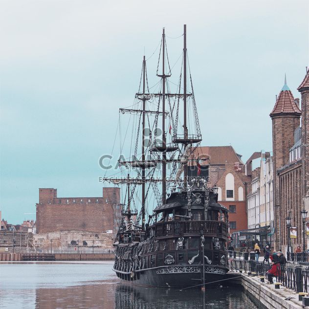 Medieval ship on pier of an old town - бесплатный image #335271