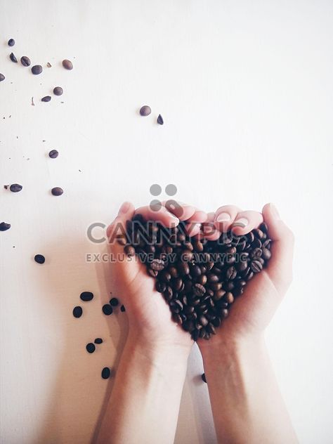 Coffee beans in hands - image #337891 gratis