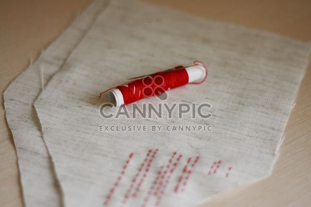 red bobbin thread with needle and stitches - бесплатный image #342601