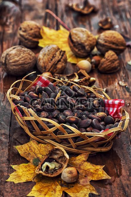 nuts, seeds and maple leaf on a wooden table - image #342891 gratis