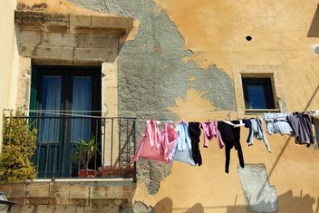 Laundry hanging on rope outside house - бесплатный image #346251