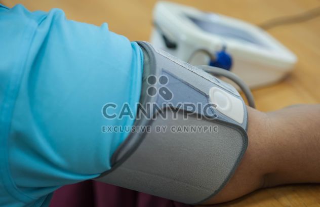 Person checking blood pressure at table - image gratuit #347251 