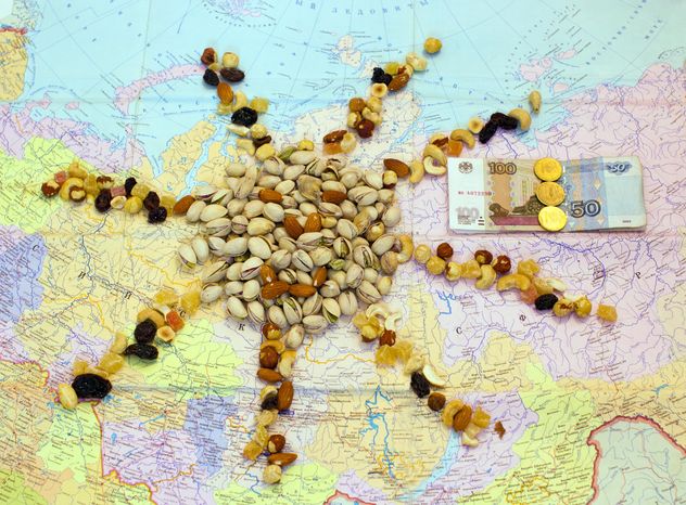 Pistachio nuts, candied fruit and money on map - бесплатный image #347921