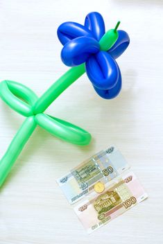 Balloon in shape of flower and money on white background - бесплатный image #347931