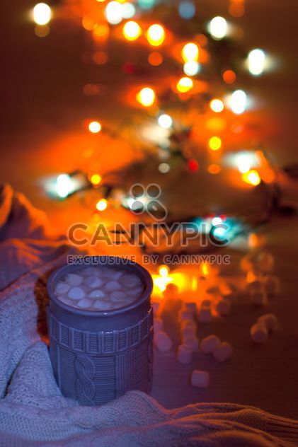 Cup of cocoa with marshmallows in light of garlands - image #347951 gratis