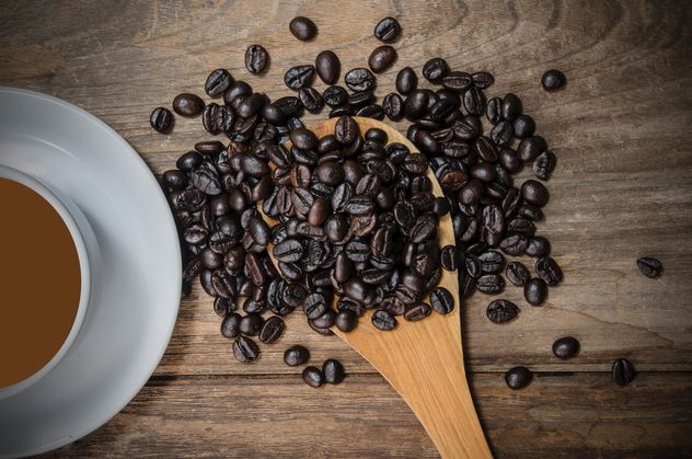 Cup of coffee and roasted coffee beans in spoon - бесплатный image #452451