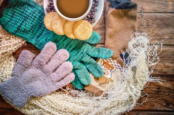 Warm accessories, cookies and cup of coffee over wooden background - бесплатный image #452501