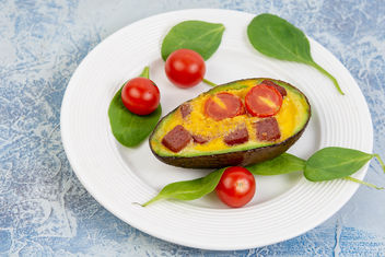 Baked Avocado with Eggs Cherry Tomato and Sausages on the white plate - Free image #464391
