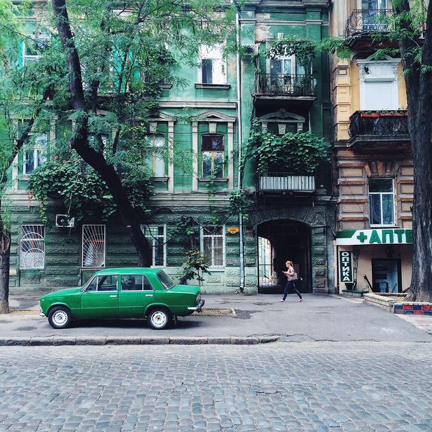 Architecture and green car in the street - бесплатный image #136221