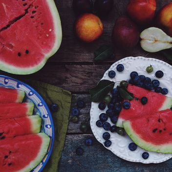 Summer fruits food-collage on a dark wooden table - бесплатный image #136251