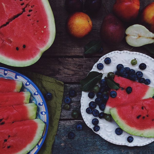 Summer fruits food-collage on a dark wooden table - бесплатный image #136251
