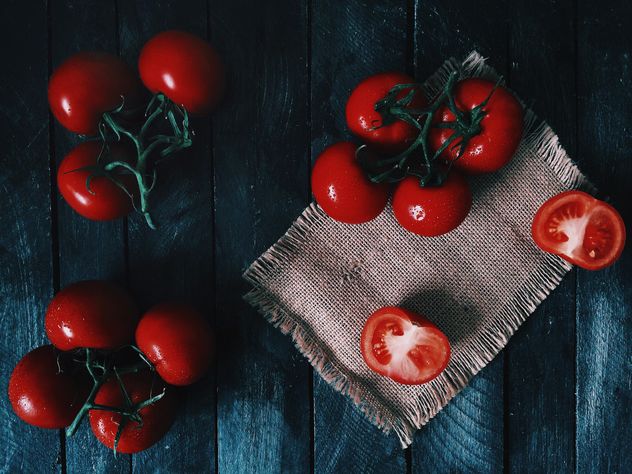 Ripe tomatoes on wooden background - image #136501 gratis