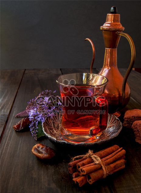 Cup of tea with cookies, cinnamon and dates - image #136681 gratis