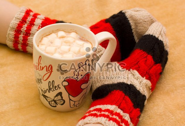 Mug of cocoa and feet in warm socks - image #182561 gratis