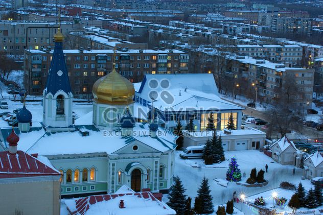 Aerial view on church and houses in winter town - бесплатный image #182631