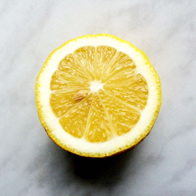 Half of lemon on a gray background - image gratuit #183221 