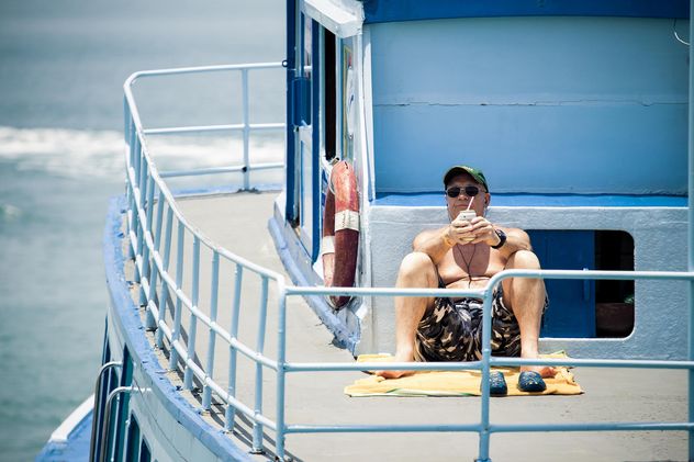 Man relaxing on yacht - image #183451 gratis