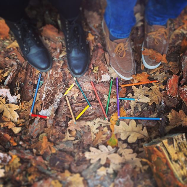 Couple of feet near word Love made of pencils on fallen leaves, #autumncity - Free image #183651