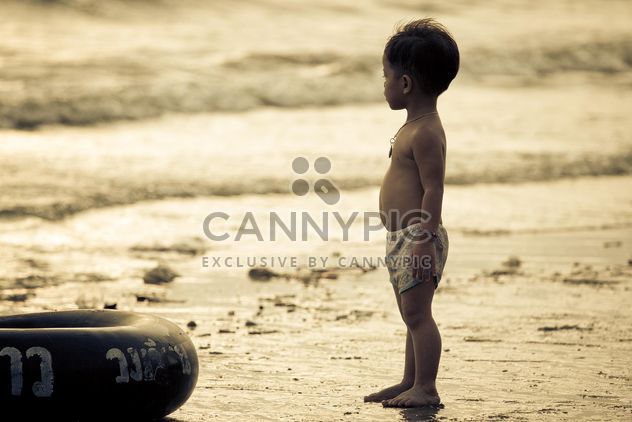 Small Asian boy on seashore at sunset - Free image #183851