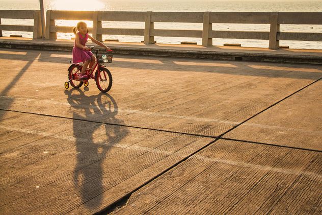 Girl riding bicycle at sunset - Free image #183961