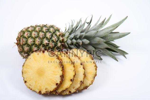 Whole and sliced pineapples on white background - image #187801 gratis