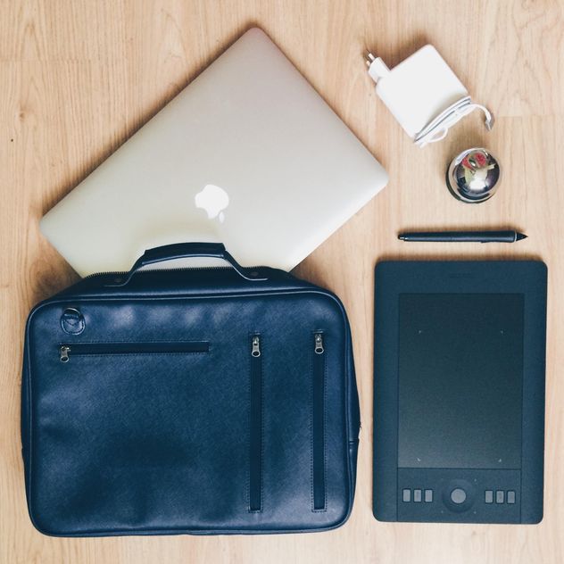 Macbook, tablet PC and designer's bag on wooden background - бесплатный image #271731