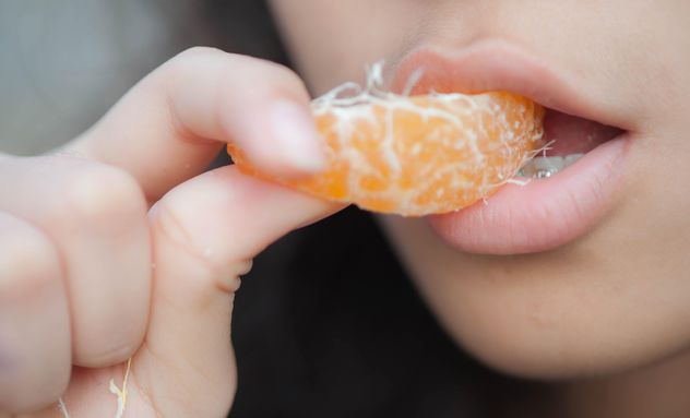 Girl eating peeled tangerine - image #301941 gratis