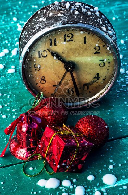Christmas decorations and old clock on green wooden background - бесплатный image #302031