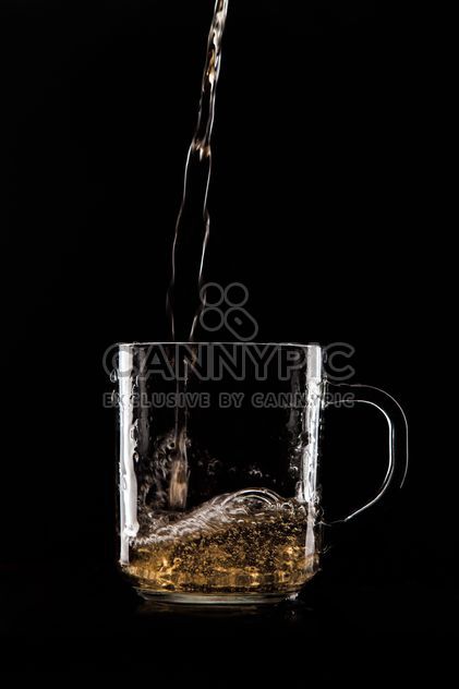 Glass cup on black background - image #303221 gratis