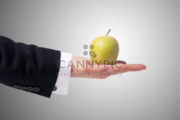 Apple in man's hand - image #303331 gratis