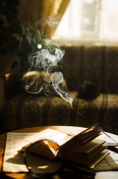 Autumn yellow leaves through a magnifying glass and incense sticks and book - бесплатный image #330401