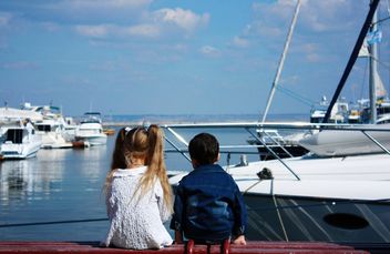 Boy and girl sitting on enbankment - image #333221 gratis