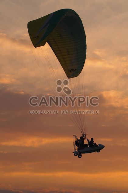 Flying paramotor in sky at sunset - бесплатный image #347021