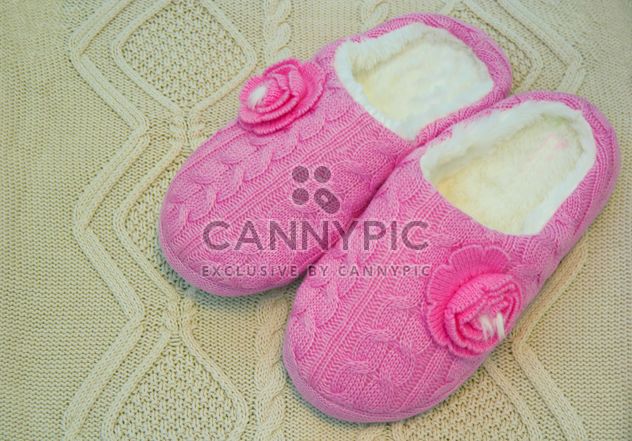 Warm pink slippers on knitted background - бесплатный image #347911