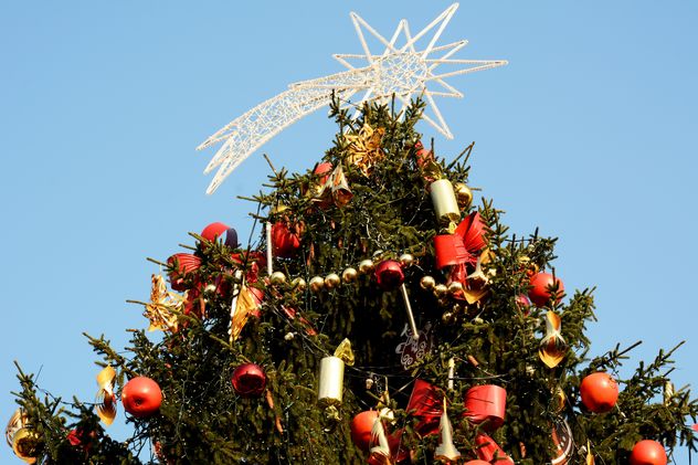 Decorated Christmas tree against blue sky - бесплатный image #348431