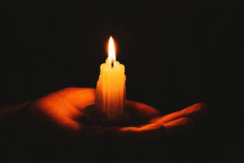 Burning candle on a female hand, dark background. Symbol of life, love and light - бесплатный image #474701