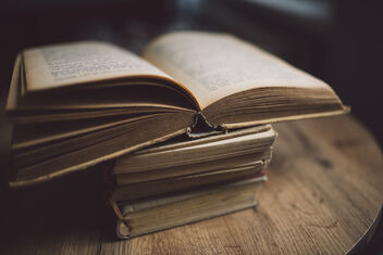 Old books placed on an old wooden office table. - Free image #477251